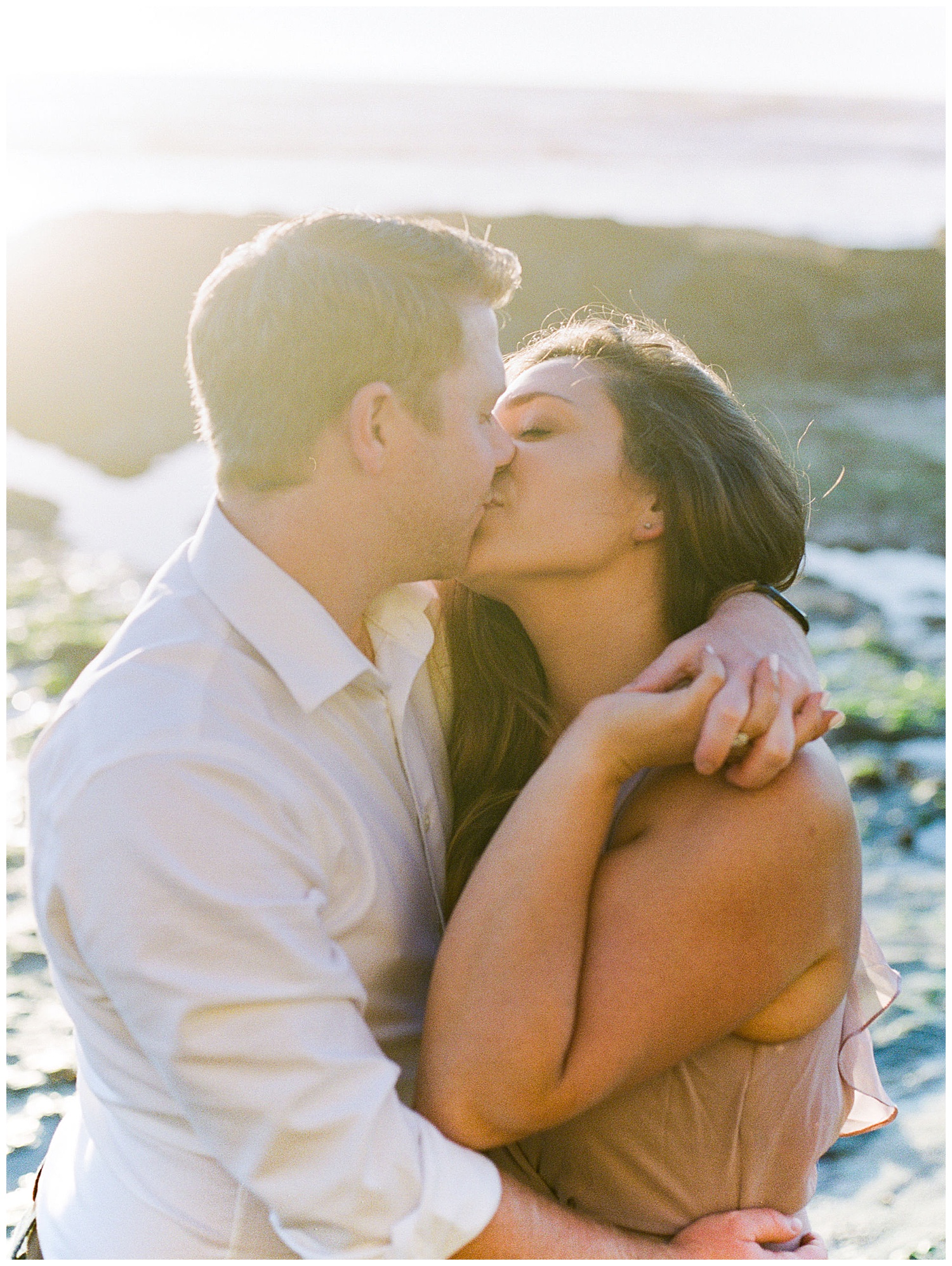 engaged couple kissing during engagement session 