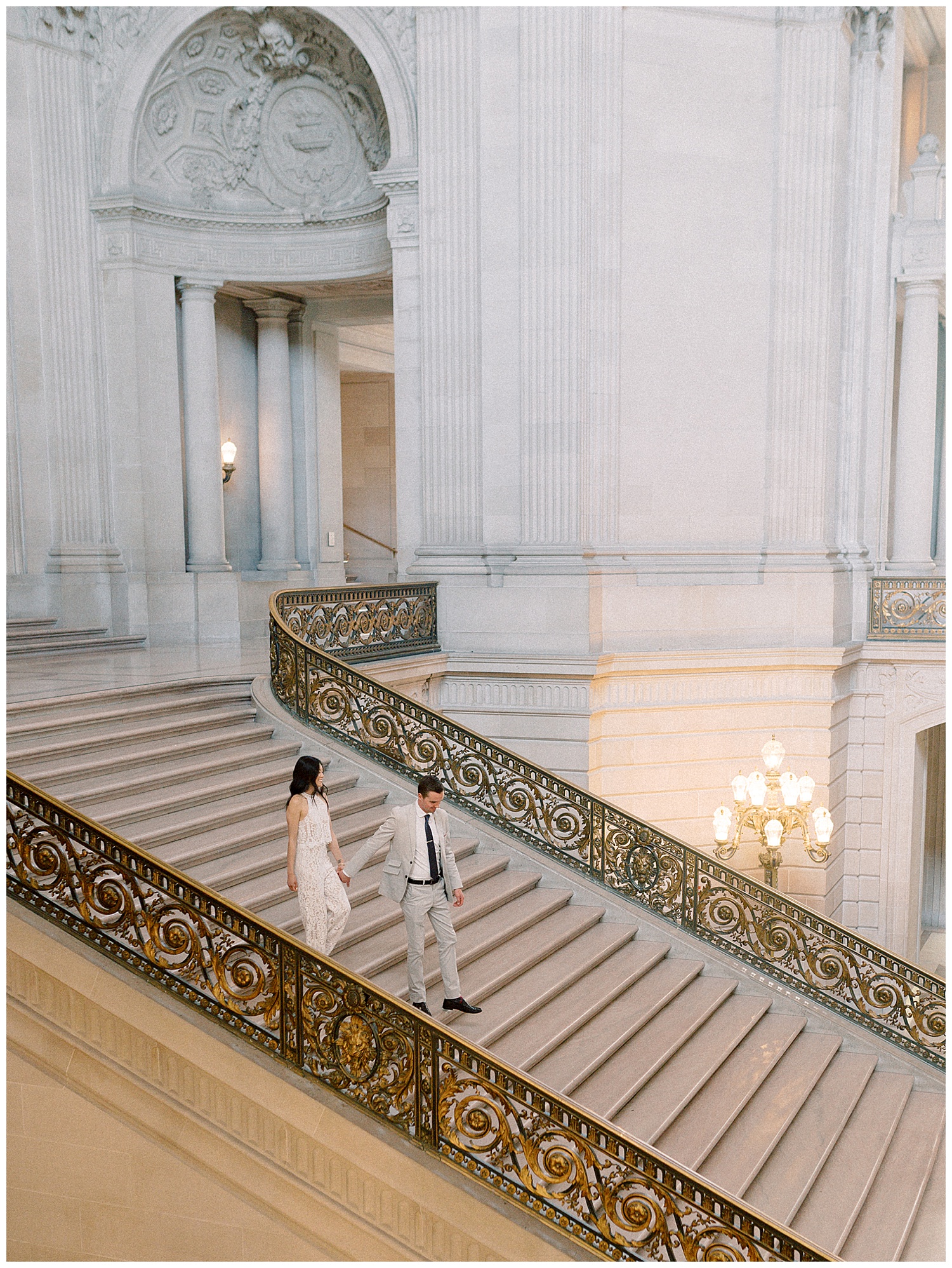 couple going the steps of san francisco city hall