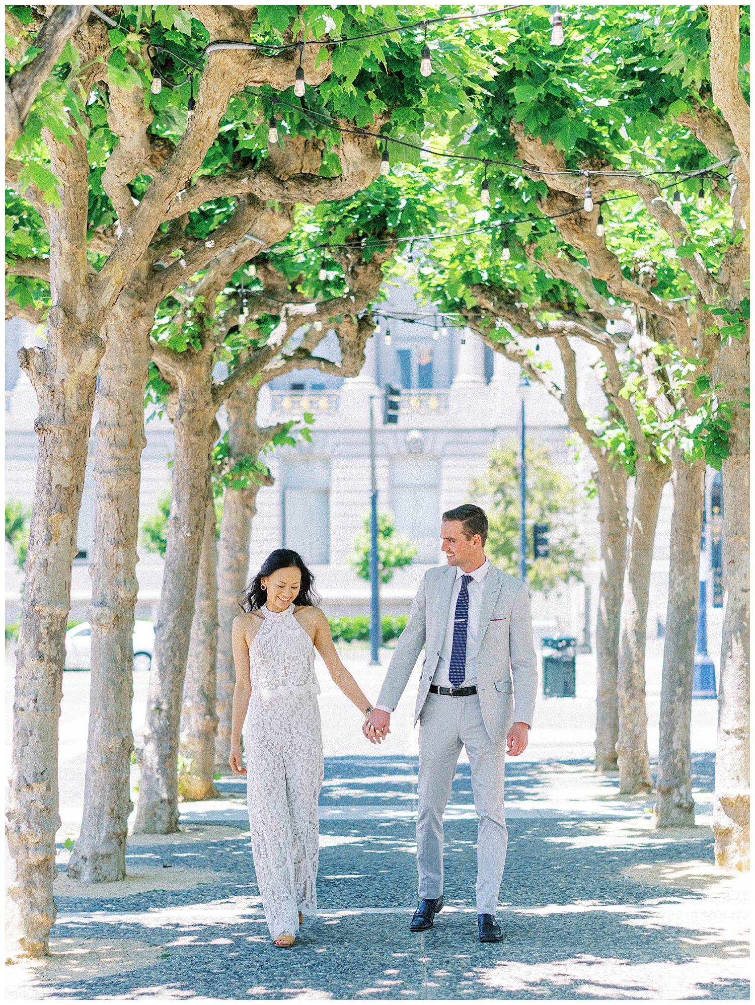 walking photo of bride and groom outside san francisco city hall