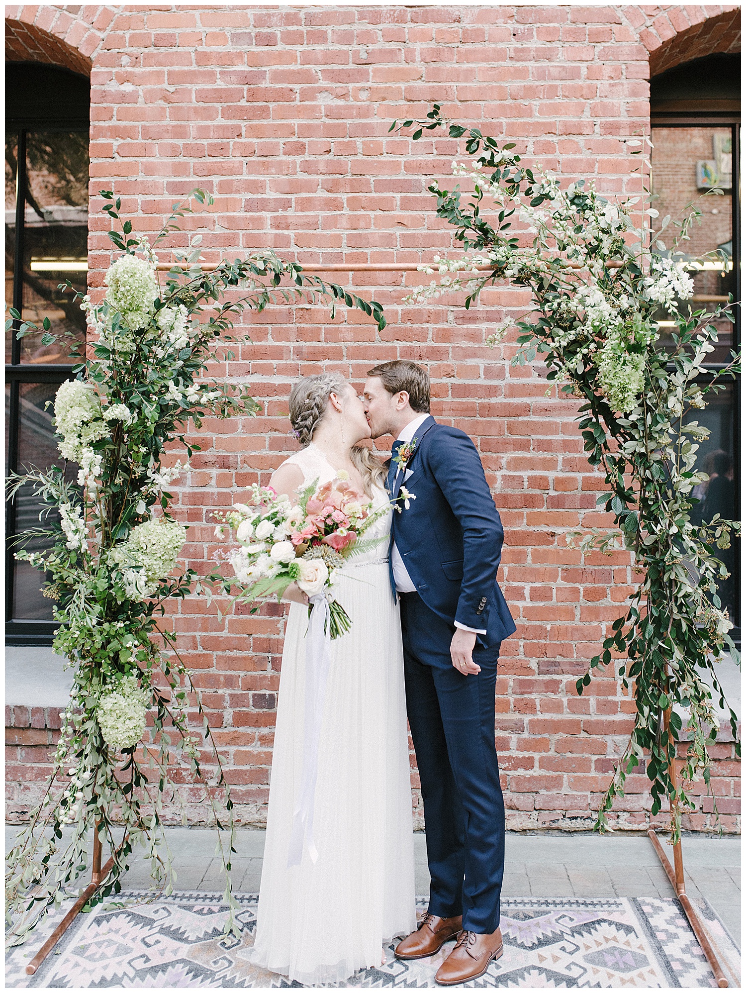 full portraits of bride and groom kissing