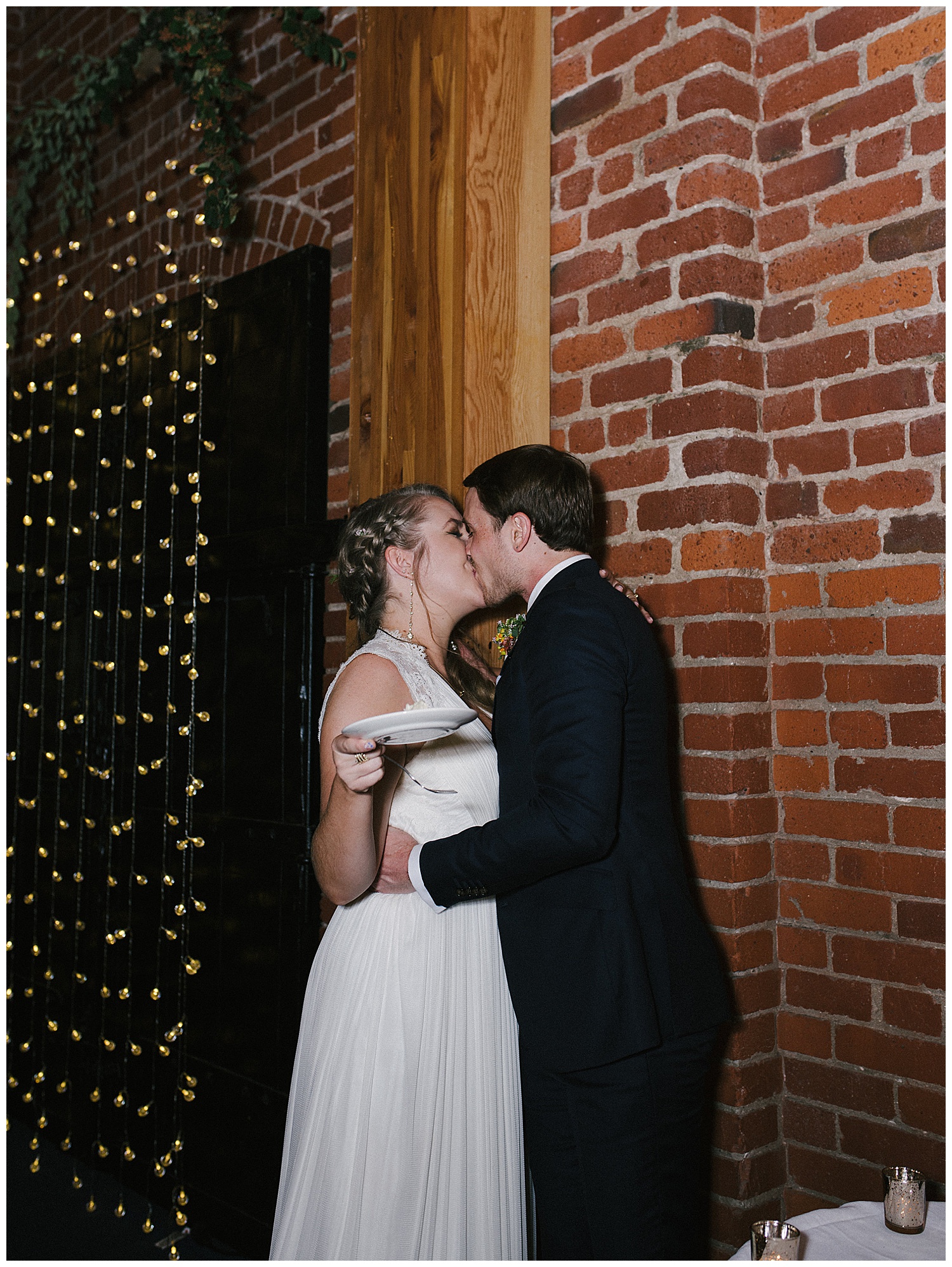 groom and bride kissing with cake