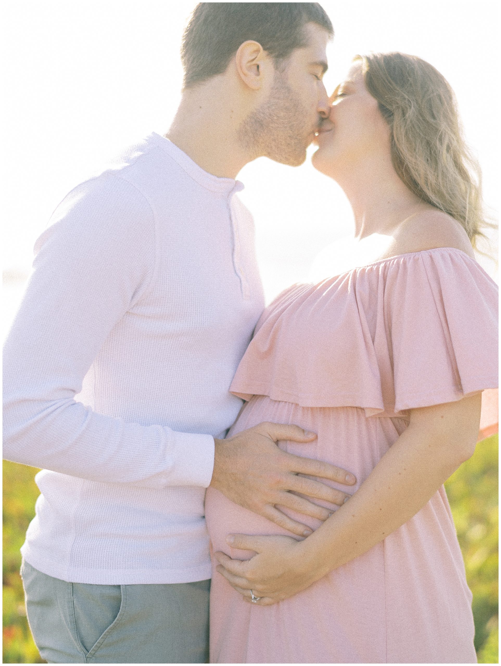 husband kissing pregnant wife